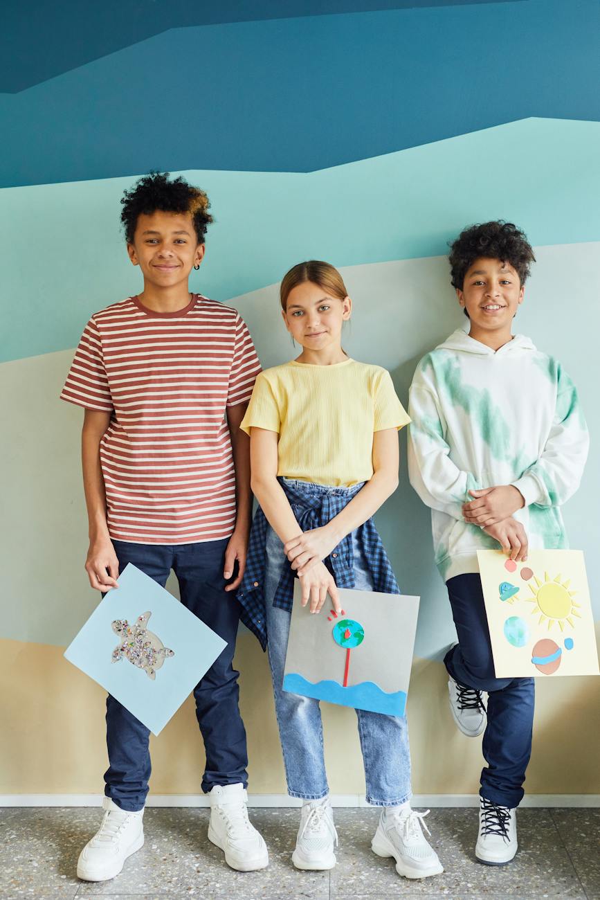 young students holding their art projects